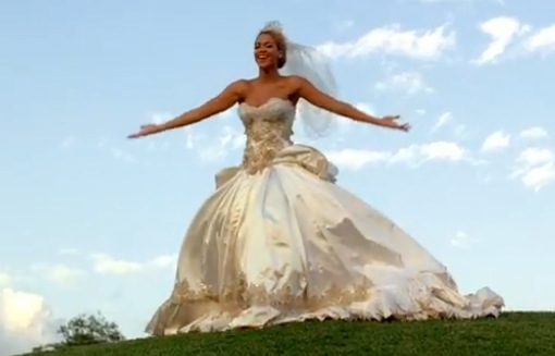 pnina tornai wedding dress WITH FLOWERS ON THE TOP AND BOTTOM OF THE DRESS